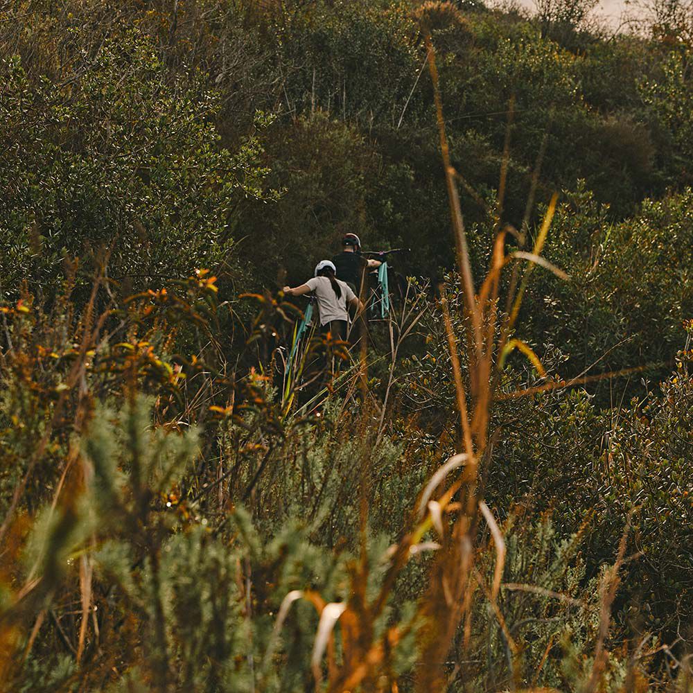 Man and woman walking upward on trail